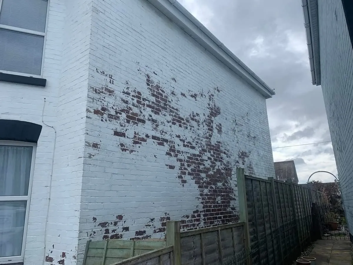 Peeling paint on a brick wall before redecoration in Newquay