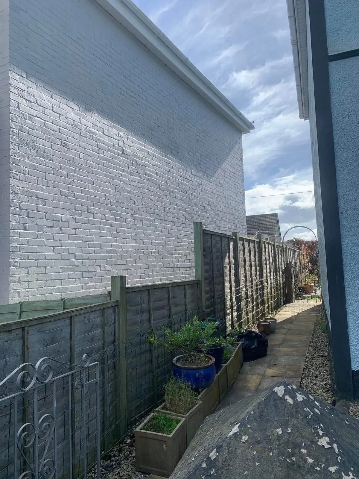 Freshly painted brick wall after preparation and masonry paint in Newquay